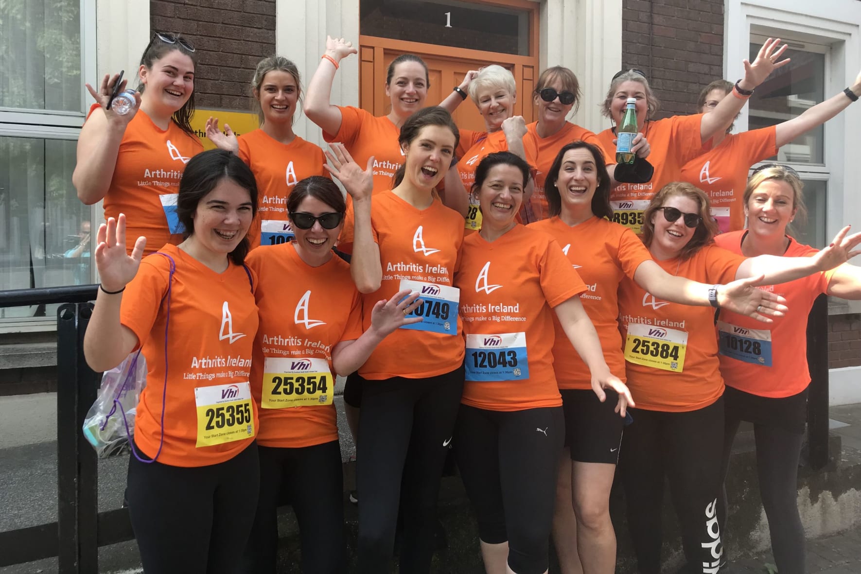 Group of mini marathon women in front of Arthritis Ireland office.