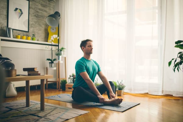 young man doing yoga at home